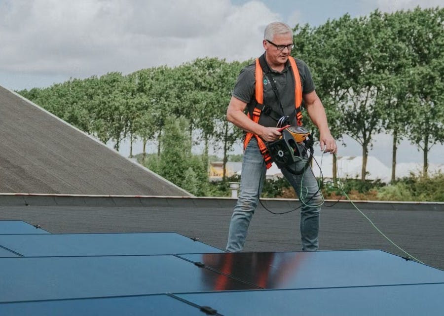 Inspecteur die een elektrakeuring Scope 12 uitvoert op een dak met zonnepanelen