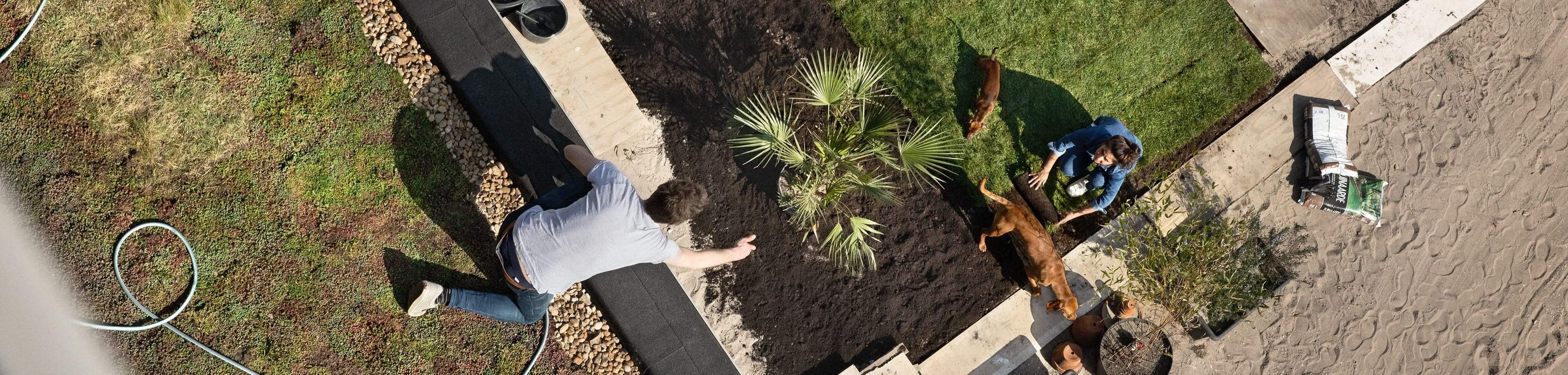 Een man is aan het werk op het groene dak van zijn woning
