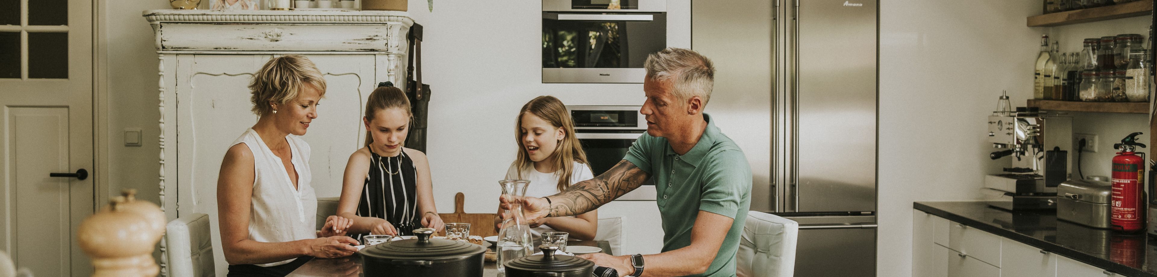 Gezin zit te eten aan de keukentafel